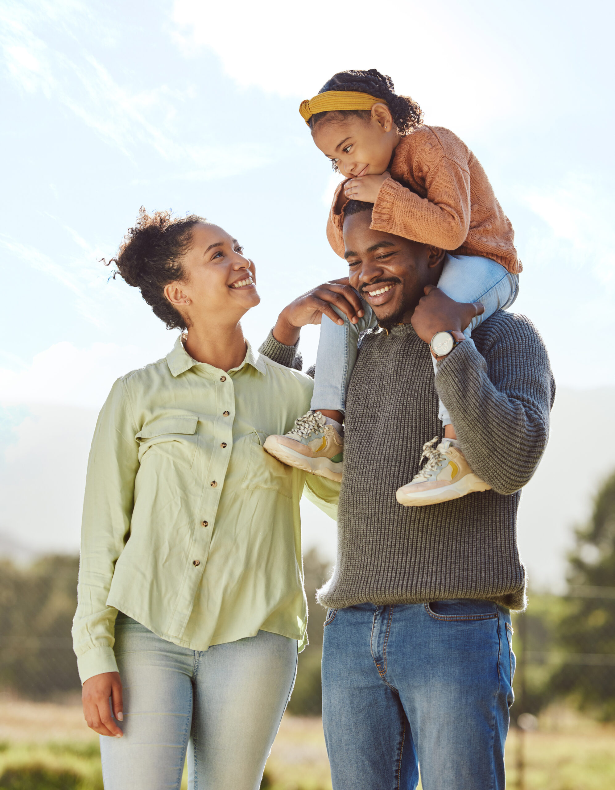 Parents, kids and happy family in park, garden and sunshine field outdoors for bonding, love and quality time together. Mom, dad and girl child of black family having fun, relax and care in nature