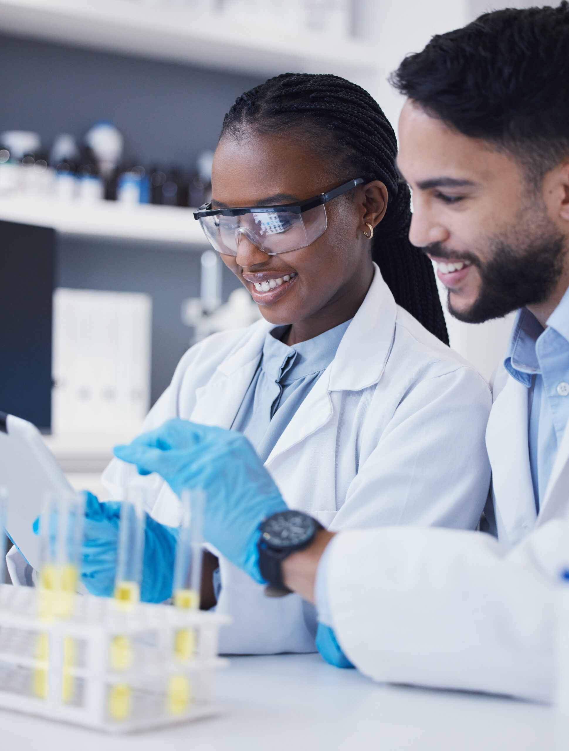 Test tube, laboratory and scientist people for medical research, vaccine solution and data analysis teamwork. Healthcare, science partner and happy woman with medicine or liquid inspection or check